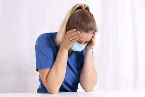 bigstock tired and exhausted nurse or d 443201834 1